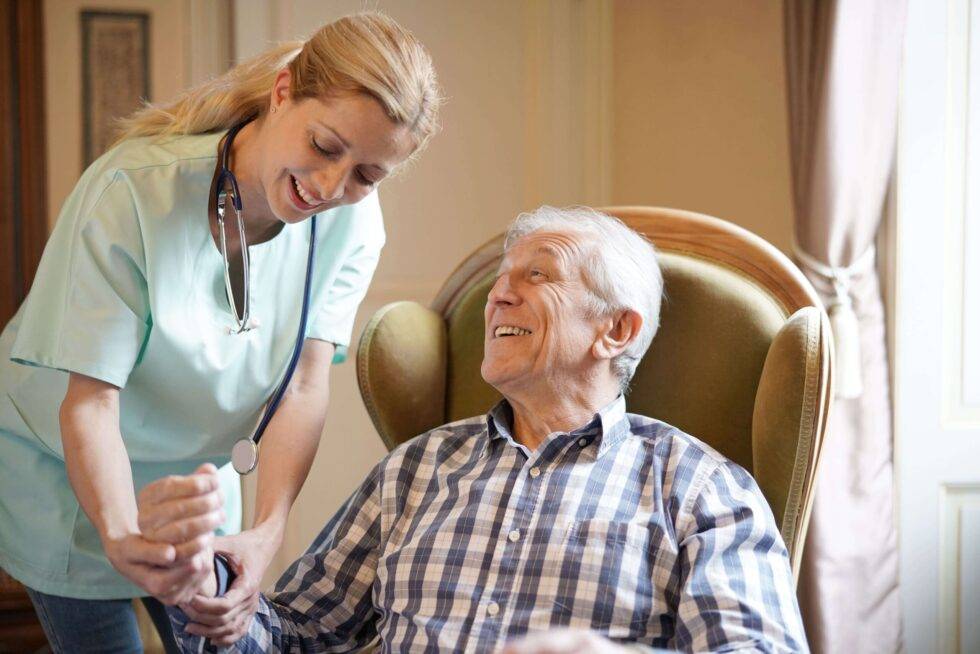 home health care aid checking patient’s blood pressure