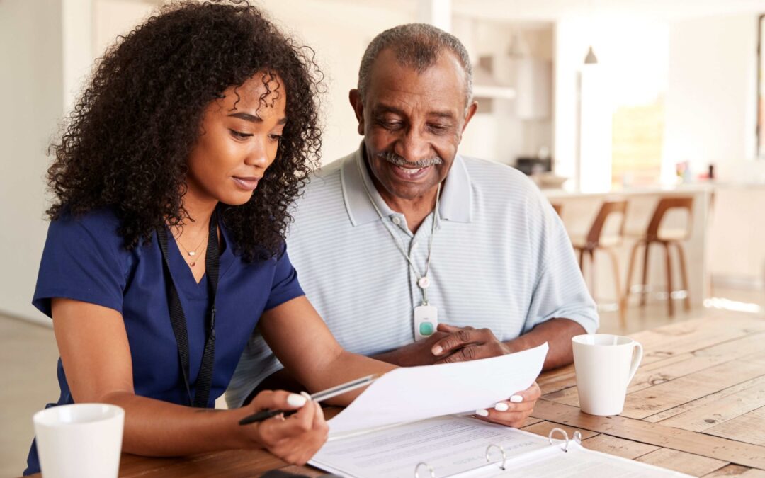 home care aide discussing schedule with senior man