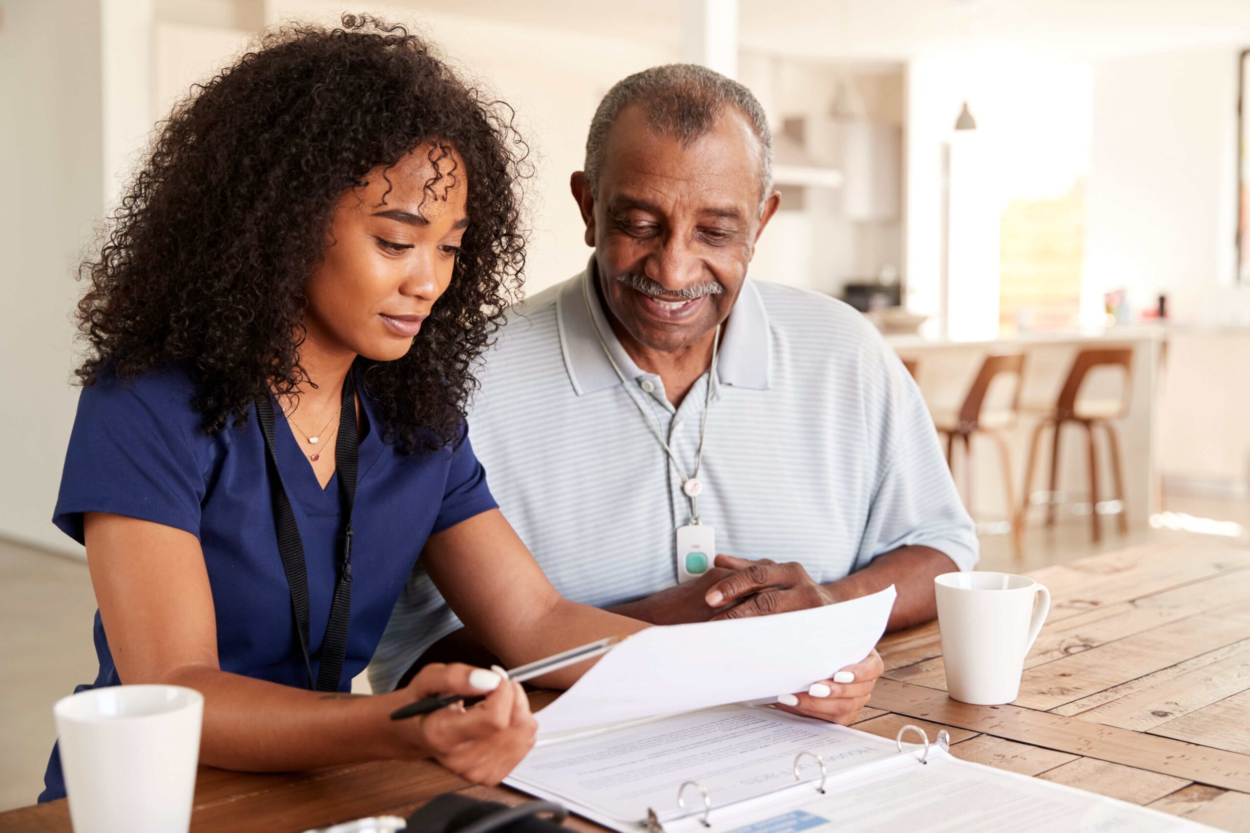 home care aide discussing schedule with senior man