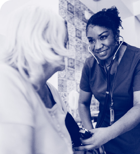 A doctor wearing a stethescope and checking a patient
