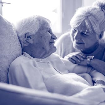 elder couple smiling at one another
