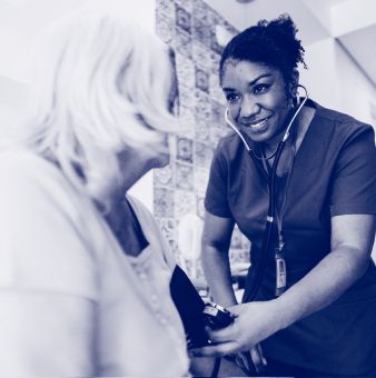 A doctor wearing a stethescope and checking a patient